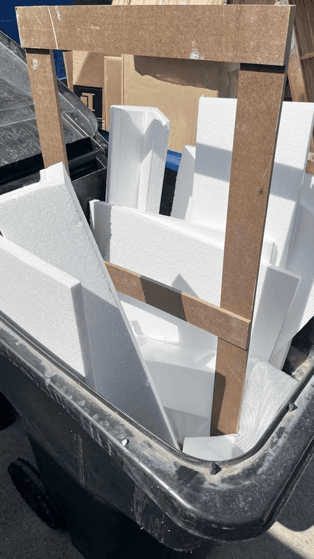A pile of white foam in a dumpster